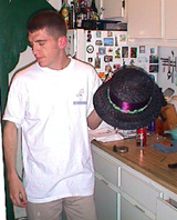 bryan holds the finished hat in our kitchen